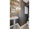 Small powder room featuring a pedestal sink, toilet, and charming plaid wallpaper design at 5628 Fallsbrook Nw Knl, Acworth, GA 30101