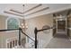 Spacious upstairs hallway featuring a trey ceiling, plush carpet, and natural light at 5628 Fallsbrook Nw Knl, Acworth, GA 30101