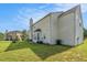 Spacious backyard with a well maintained lawn and a view of the home's exterior at 1027 Fellowship Rd, Fairburn, GA 30213