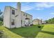 A spacious backyard featuring lush grass, a patio set, and a fire pit at 1027 Fellowship Rd, Fairburn, GA 30213