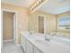 This bathroom features a double sink vanity with white cabinets and tile floors at 1027 Fellowship Rd, Fairburn, GA 30213