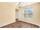 Dining room with hardwood floors, neutral walls, and natural light shining through large windows at 1027 Fellowship Rd, Fairburn, GA 30213