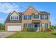 Charming two-story brick home with blue shutters and well-manicured lawn at 1027 Fellowship Rd, Fairburn, GA 30213