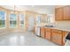 Bright kitchen features tile flooring, natural wood cabinets and stainless steel dishwasher and sink at 1027 Fellowship Rd, Fairburn, GA 30213