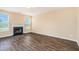 Spacious living room with fireplace, wood floors, and lots of windows at 1027 Fellowship Rd, Fairburn, GA 30213