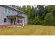 Spacious backyard featuring a covered patio and well-manicured lawn, perfect for outdoor gatherings at 1800 Pearson St, Loganville, GA 30052