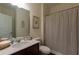 Bathroom featuring a vanity, toilet, and shower with a striped curtain at 1800 Pearson St, Loganville, GA 30052