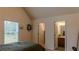 Bedroom with ensuite access and a bright window, creating a relaxing atmosphere at 1800 Pearson St, Loganville, GA 30052