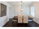 Formal dining room featuring a wooden table, upholstered chairs, and modern lighting at 1800 Pearson St, Loganville, GA 30052