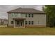 Rear exterior of the home showing a large backyard with a covered patio, ideal for outdoor entertaining at 1800 Pearson St, Loganville, GA 30052