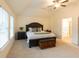 Vaulted ceiling primary bedroom with large windows and en suite bathroom at 1800 Pearson St, Loganville, GA 30052