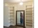 Walk-in closet with custom organizers, adjustable shelves, and a full-length mirror at 1800 Pearson St, Loganville, GA 30052