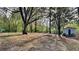 Large wooded backyard with a storage shed nestled among mature trees at 4111 Sweet Water Ct, Conyers, GA 30094