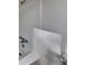 Modern bathroom featuring a shower with chrome fixtures and a white tiled surround at 4111 Sweet Water Ct, Conyers, GA 30094