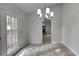 Bright dining area featuring modern chandelier and door leading to the outdoors at 4111 Sweet Water Ct, Conyers, GA 30094