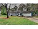 Charming home featuring a manicured front lawn, a two-car garage, and classic landscaping at 4111 Sweet Water Ct, Conyers, GA 30094