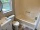 Cozy bathroom features a vanity, toilet, and shower tub combo at 6286 Cooper St, Douglasville, GA 30134