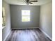 Bedroom with a window, ceiling fan, and wood-look flooring at 6286 Cooper St, Douglasville, GA 30134