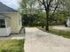 View of the long driveway on the side of the house with lawn at 6286 Cooper St, Douglasville, GA 30134