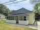 Charming, cottage style home with a covered front porch and yellow siding at 6286 Cooper St, Douglasville, GA 30134