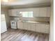 Bright kitchen featuring white cabinets, neutral countertops, and stainless steel appliances at 6286 Cooper St, Douglasville, GA 30134