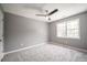 Bedroom with a ceiling fan and large window providing natural light at 74 Venture Path, Hiram, GA 30141
