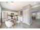Bright kitchen features white cabinetry, stainless steel appliances and adjacent dining area at 74 Venture Path, Hiram, GA 30141