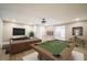 Spacious living room features a pool table, TV, modern sofa and beautiful décor at 74 Venture Path, Hiram, GA 30141