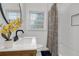 Cozy bathroom with striped shower curtain, sleek faucet, and plants at 1386 Sandy Ln, Decatur, GA 30032