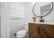 Charming half bathroom features modern vanity with round mirror and marble countertop at 1386 Sandy Ln, Decatur, GA 30032