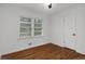 Cozy bedroom features hardwood floors and a view from two windows at 1386 Sandy Ln, Decatur, GA 30032