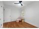 Bright bedroom with hardwood floors, chair, and a ceiling fan at 1386 Sandy Ln, Decatur, GA 30032