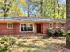 Charming brick home with a well-maintained front yard and mature trees at 1386 Sandy Ln, Decatur, GA 30032