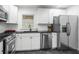 Modern kitchen featuring white cabinets, granite countertops and stainless steel appliances at 1386 Sandy Ln, Decatur, GA 30032