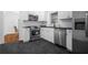 Modern kitchen featuring stainless steel appliances and dark hardwood floors at 1386 Sandy Ln, Decatur, GA 30032