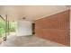 Covered patio with a brick facade, white accents, and doorway to the yard at 1386 Sandy Ln, Decatur, GA 30032