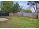 Large fenced backyard featuring a green lawn, some trees and a patio area at 2828 Marksman Trl, Austell, GA 30106