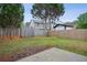Fenced backyard with green grass, mature trees, and a patio area, perfect for outdoor enjoyment at 2828 Marksman Trl, Austell, GA 30106