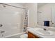 Bright bathroom features a tub with shower, white tile, and vanity with a sink at 2828 Marksman Trl, Austell, GA 30106