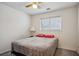 Bedroom with neutral colors, a ceiling fan, and a large window, providing natural light and a peaceful atmosphere at 2828 Marksman Trl, Austell, GA 30106