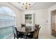 Lovely dining space features a round table, large arched window, and easy access to in-unit laundry at 2828 Marksman Trl, Austell, GA 30106