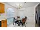 Bright dining area with decorative chandelier, arched window, and updated vinyl flooring for a fresh look at 2828 Marksman Trl, Austell, GA 30106