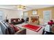 Open living room area featuring a stone fireplace, neutral carpet, and natural light at 2828 Marksman Trl, Austell, GA 30106