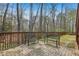 Brick patio with seating overlooks the backyard with wooded views and a wooden fence at 3887 Hickory Manor Dr, Suwanee, GA 30024