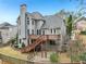 Beautiful two-story home with large windows and a wooden deck overlooking the backyard at 3887 Hickory Manor Dr, Suwanee, GA 30024
