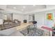 Relaxing basement with tile flooring, natural light, and comfortable sofa at 3887 Hickory Manor Dr, Suwanee, GA 30024