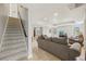 Cozy basement featuring a comfortable seating area and a staircase leading to the upper level at 3887 Hickory Manor Dr, Suwanee, GA 30024