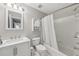 Full bathroom with shower and tub combo features white tile and modern vanity at 3887 Hickory Manor Dr, Suwanee, GA 30024