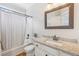 Well-lit bathroom featuring a shower-tub combo, wood-look tile floor, and a granite countertop vanity at 3887 Hickory Manor Dr, Suwanee, GA 30024