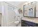 Bathroom featuring a granite countertop, dark wood vanity, tub and shower combo with elegant decor at 3887 Hickory Manor Dr, Suwanee, GA 30024